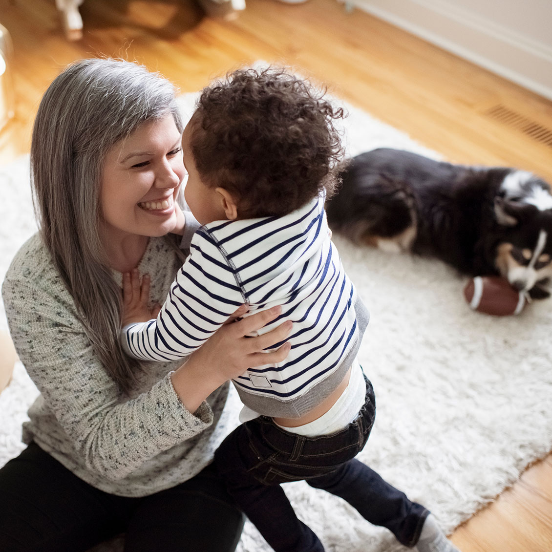Grandmother and grandchild Grandmother with toddler-aged grandchild and pet dog